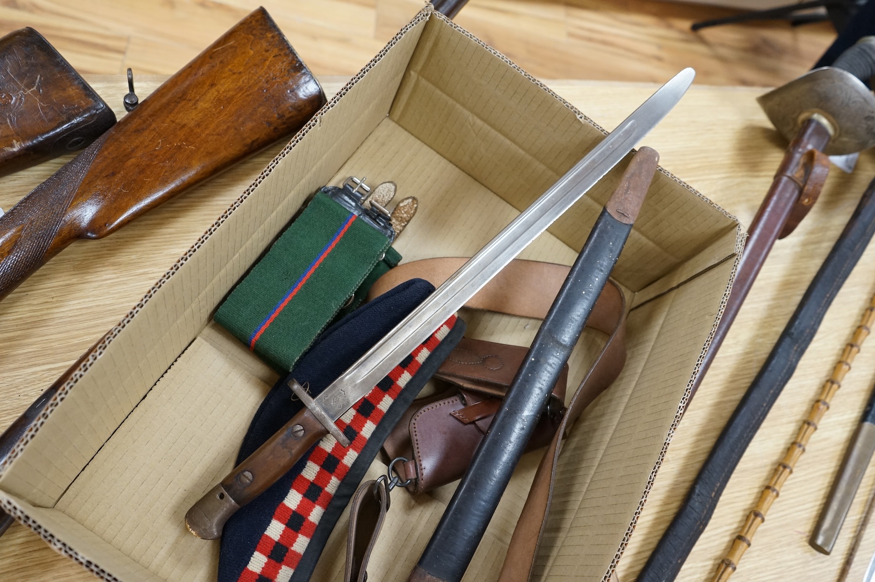 A 1907 bayonet in its scabbard with the tip of the blade shortened, together with a Glengarry cap of the KOSB, post 1902 badge and a brown leather shoulder belt and pouch with QE2 bronze badge of the Royal Artillery